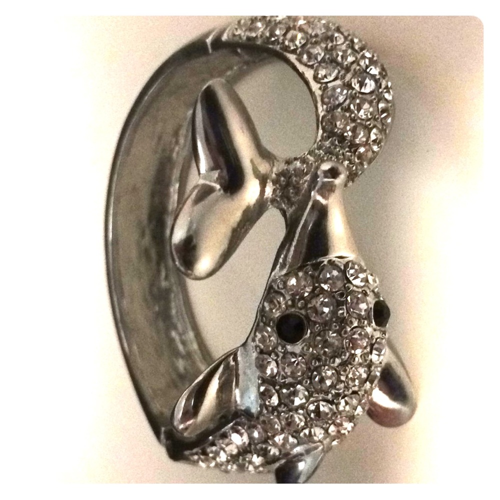 It’s a silver diamond incrusted dolphin bracelet.